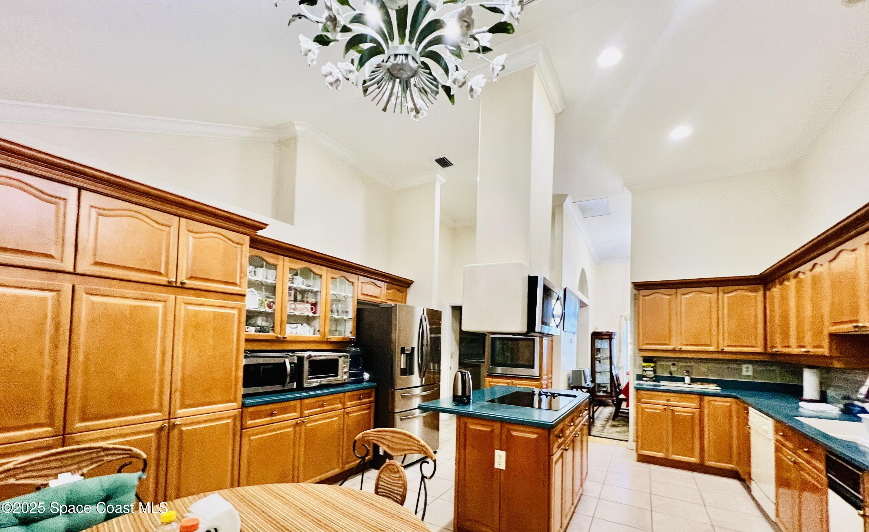 317 Lanack Road Southeast Palm Bay, FL 32909 - Photo 12 of 37 a kitchen with stainless steel appliances a sink stove and refrigerator