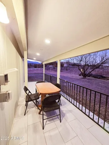 a living room with furniture a flat screen tv and kitchen view