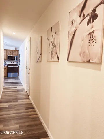 a kitchen with a refrigerator a stove top oven a dining table and chairs with wooden floor