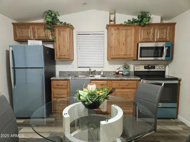 a view of house with yard and mountain view in back