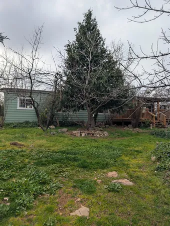 a kitchen with kitchen island granite countertop a sink counter top space and cabinets