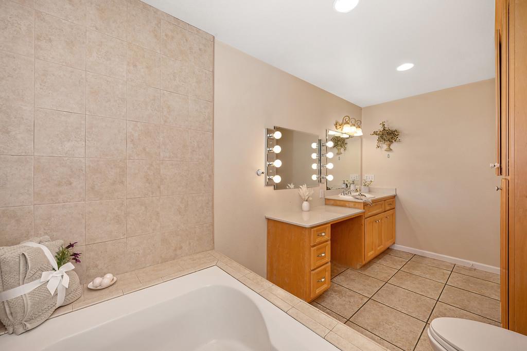 6181 Lambert Lane El Dorado, CA 95623 - Photo 35 of 68 bathroom featuring vanity, light tile patterned flooring, a garden tub, and recessed lighting