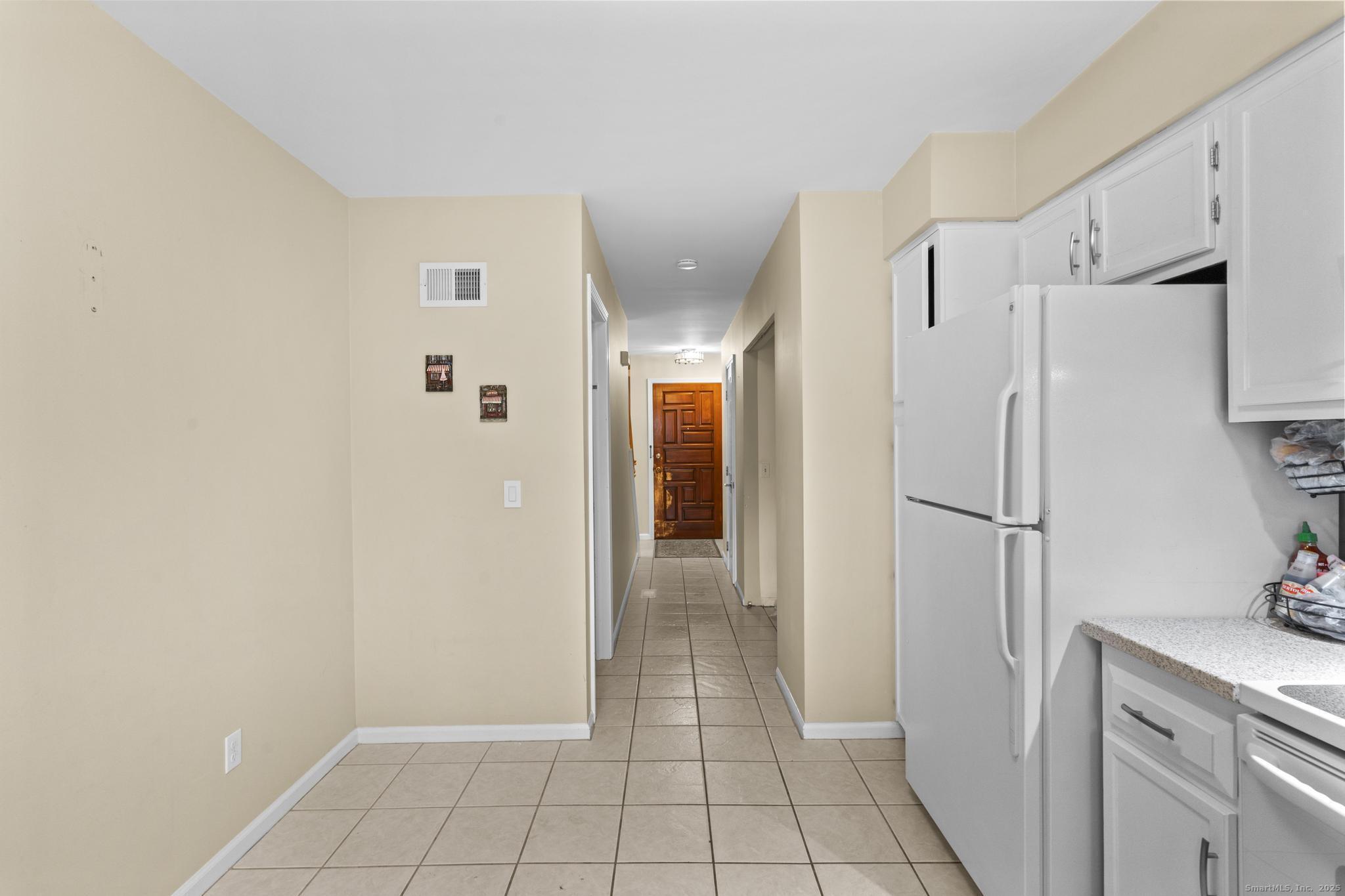 15 Derbyshire, Unit 15 Derby, CT 06418 - Photo 11 of 39 a view of a kitchen with a refrigerator and cabinets
