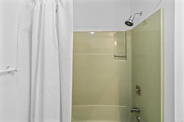 a view of an empty room with a staircase