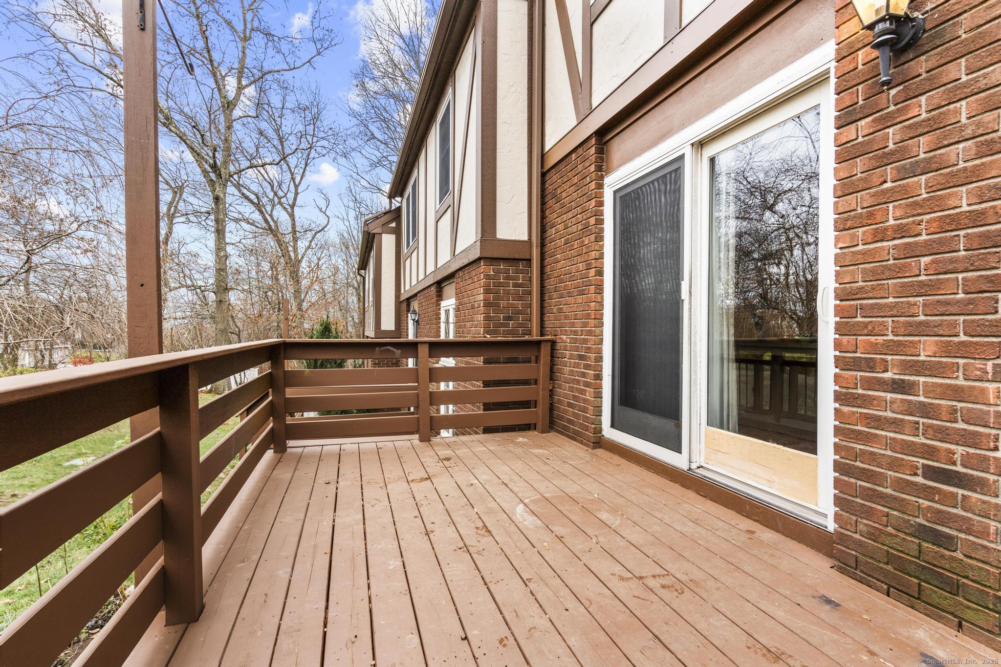 15 Derbyshire, Unit 15 Derby, CT 06418 - Photo 28 of 39 a view of a balcony with wooden floor and fence
