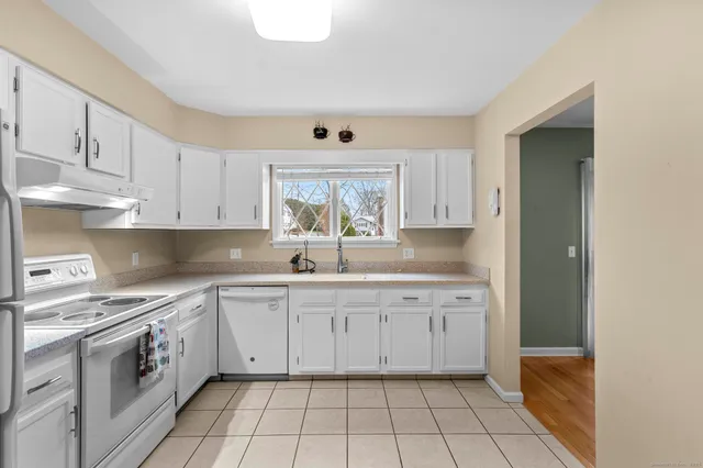a white refrigerator freezer sitting in a kitchen