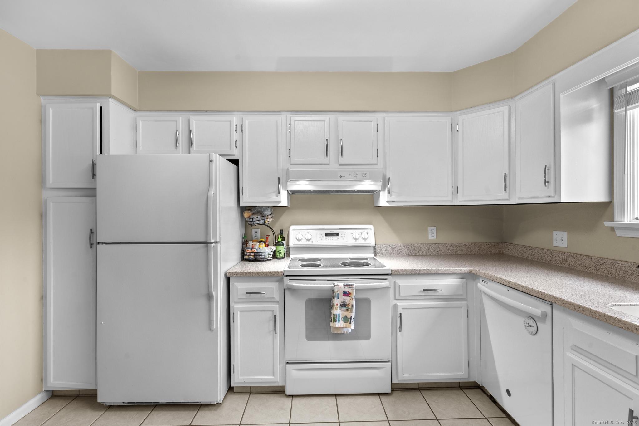 15 Derbyshire, Unit 15 Derby, CT 06418 - Photo 10 of 39 a white refrigerator freezer sitting in a kitchen