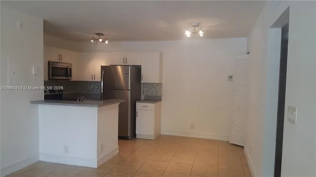 a kitchen with stainless steel appliances a refrigerator and a sink
