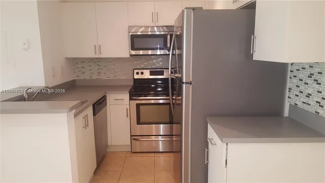 a kitchen with stainless steel appliances a refrigerator and a stove