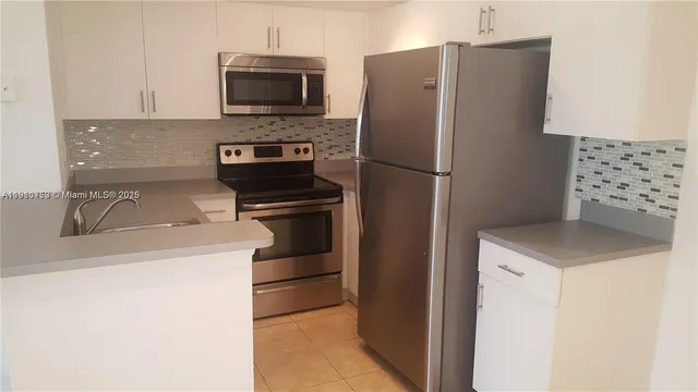 a kitchen with a refrigerator and a sink