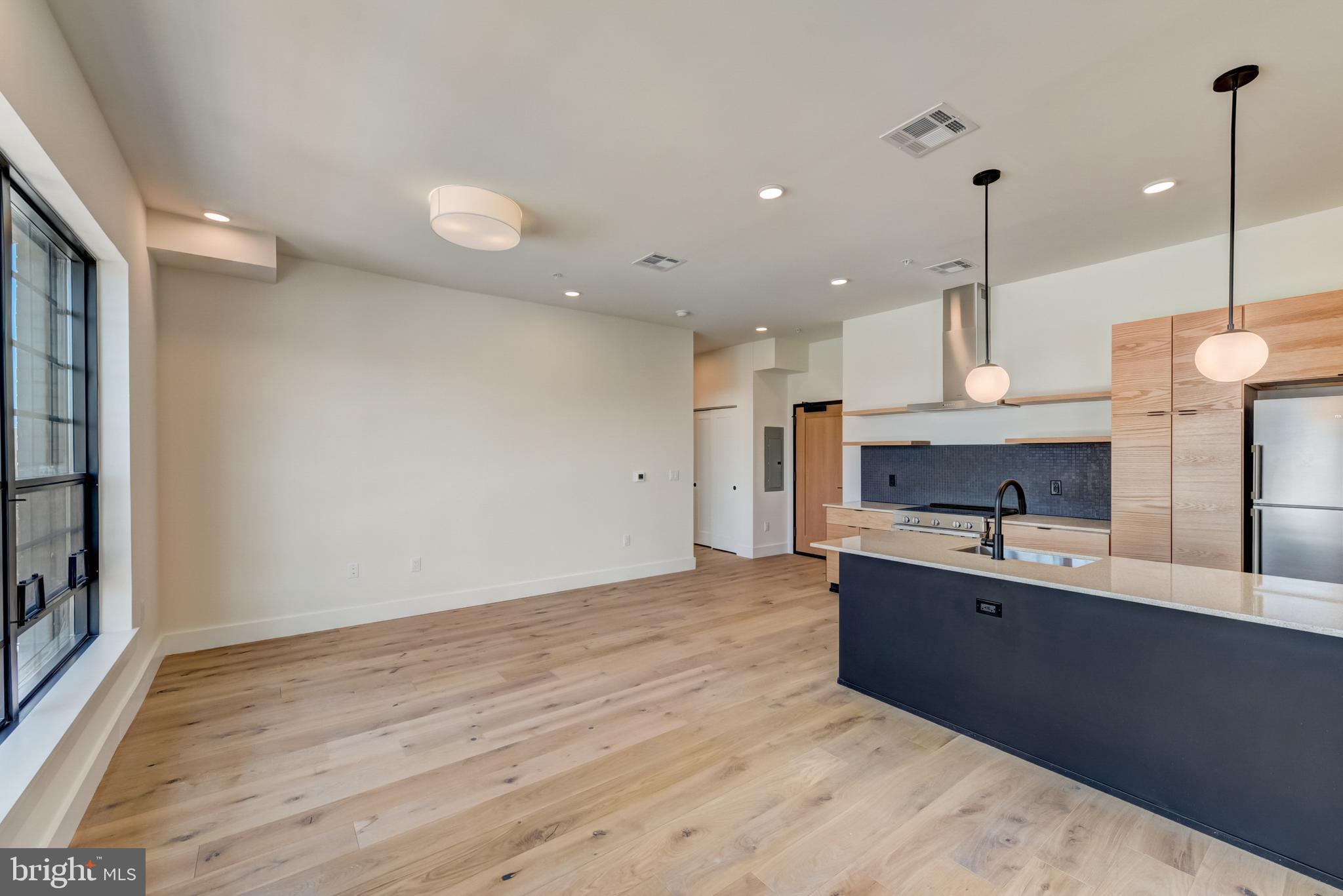 1701-15 North 2nd Street, Unit 606 Philadelphia, PA 19122 - Photo 40 of 47 a large kitchen with granite countertop a sink and a stove