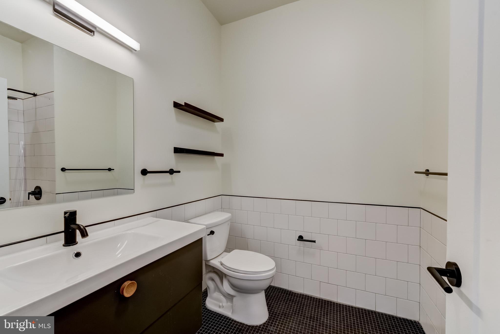1701-15 North 2nd Street, Unit 606 Philadelphia, PA 19122 - Photo 45 of 47 a bathroom with a sink a toilet and shower