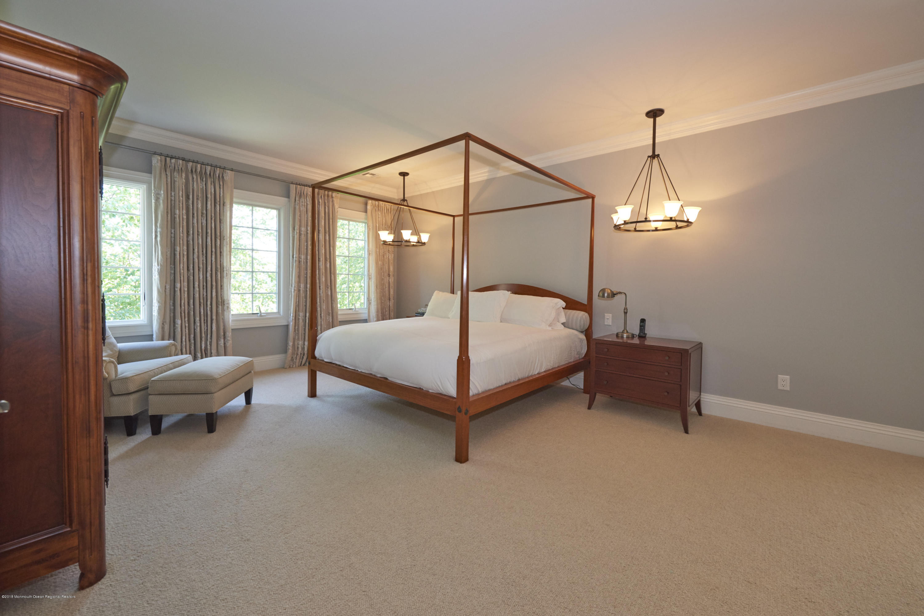 6 Willowbrook Road Rumson, NJ 07760 - Photo 21 of 33 a bedroom with a bed and a chandelier