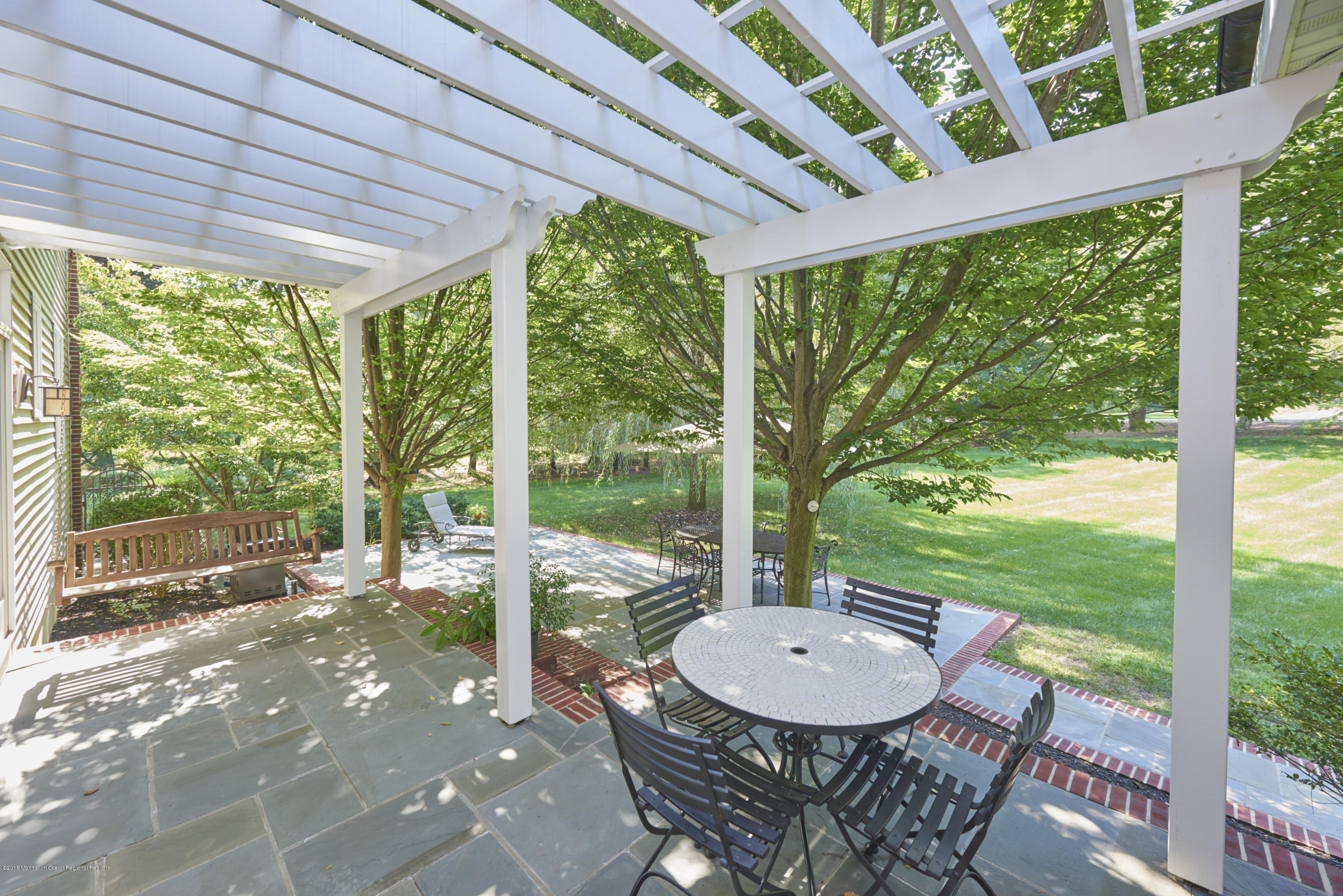 6 Willowbrook Road Rumson, NJ 07760 - Photo 32 of 33 a view of a patio with a table chairs and a backyard