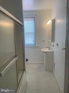 a bathroom with a glass shower door