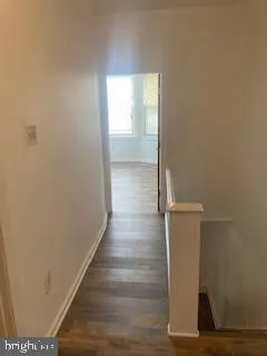 an empty room with wooden floor and closet