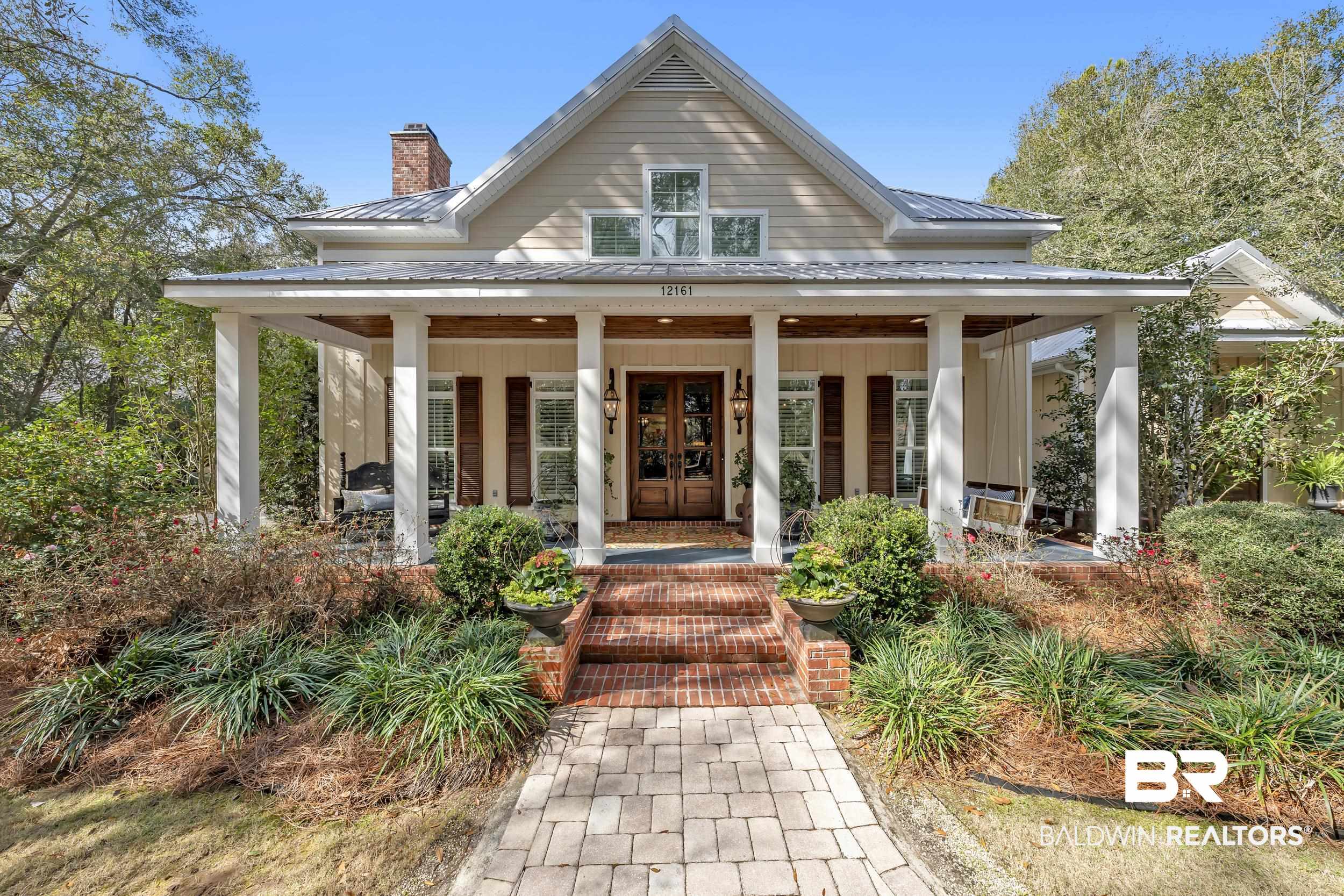 12161 Jessamine Street Magnolia Springs, AL 36555 - Photo 2 of 70 Property entrance with a chimney, covered porch, and a metal roof