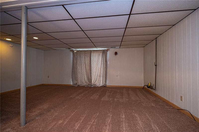 2531 Hunting Ridge Trail Bridgeville, PA 15017 - Photo 11 of 24 Game days & movie nights will be a big hit in the large lower level game room. Newer patio door leads out to the fenced in back patio.