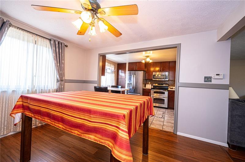 2531 Hunting Ridge Trail Bridgeville, PA 15017 - Photo 3 of 24 Dining Room with engineered bamboo flooring and bright light straming thru a large window.