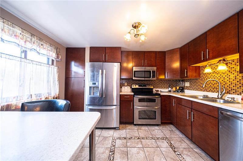 2531 Hunting Ridge Trail Bridgeville, PA 15017 - Photo 4 of 24 This beautifully renovated kitchen boasts stainless steel appliances, a pantry, glass tile back splash and decorative ceramic tile floor.