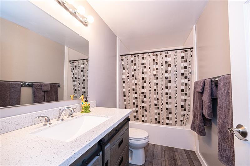 2531 Hunting Ridge Trail Bridgeville, PA 15017 - Photo 9 of 24 Main bathroom has been renovated with a barn door style cabinet that offers plenty of stoarge for all of your essentials.