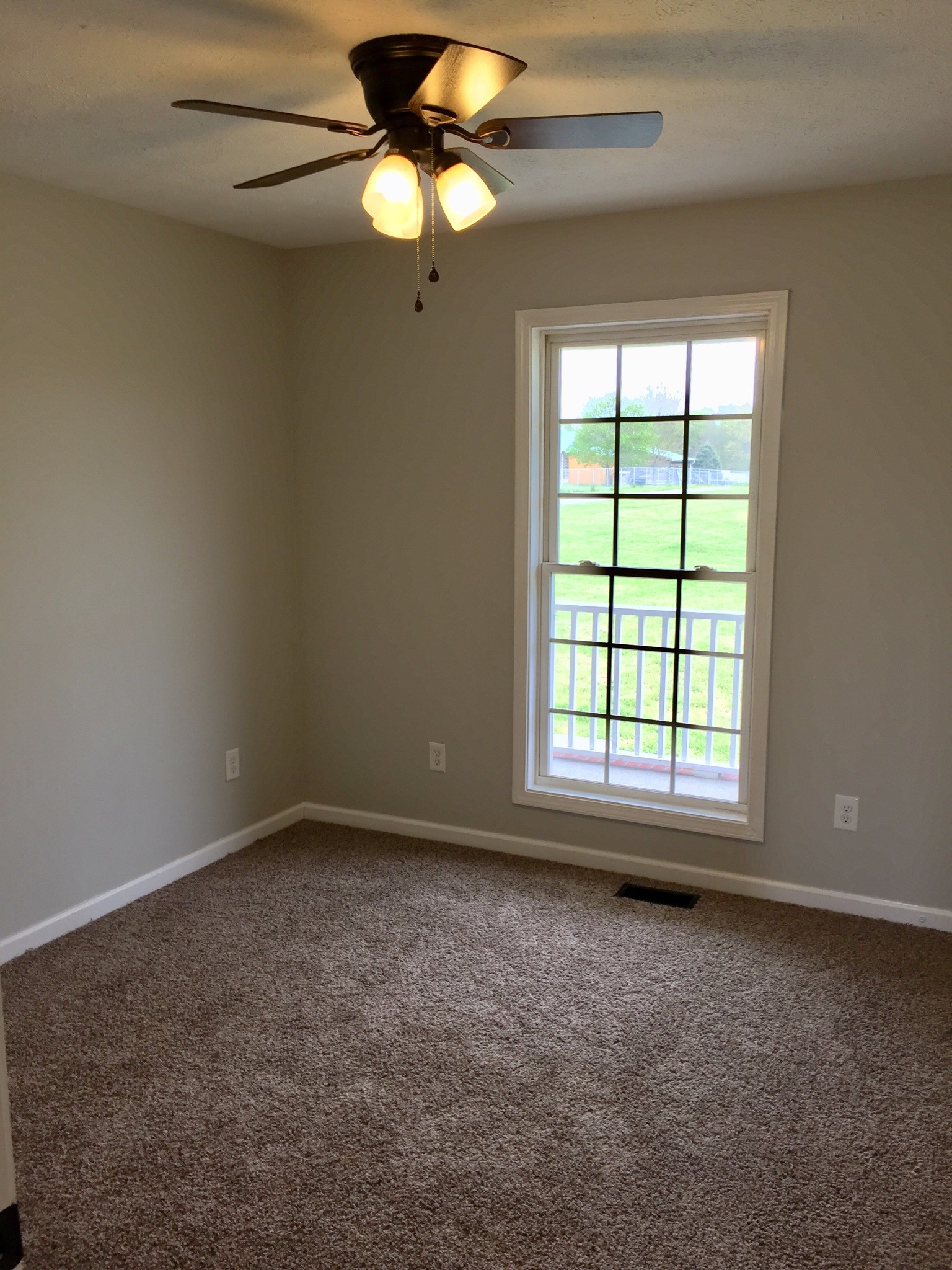 5722 Bill Anderson Road Portland, TN 37148 - Photo 11 of 11 an empty room with a window and a fan