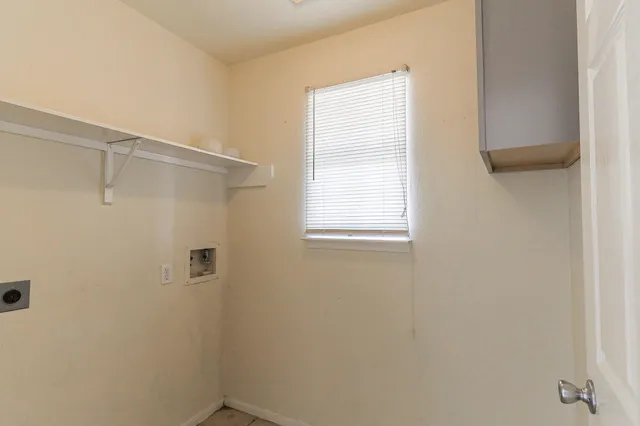 an empty room with a window and a ceiling fan