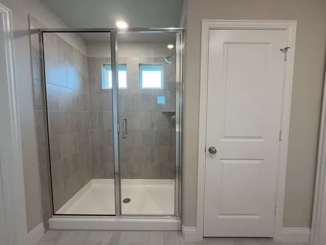 a bathroom with a glass shower door