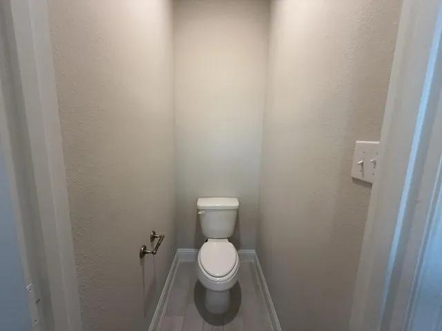 a white toilet sitting in a bathroom