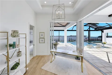 a kitchen with stainless steel appliances granite countertop a large stove a sink dishwasher and white cabinets with wooden floor