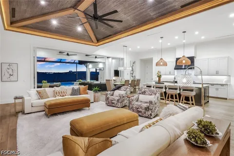 a kitchen with a dining table chairs sink and stove