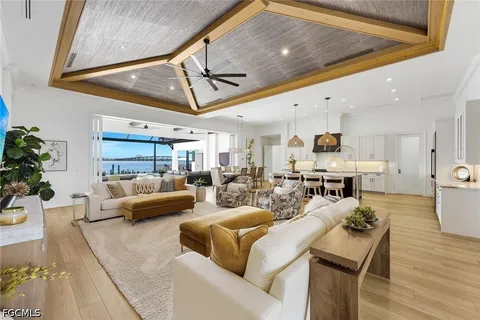 a dining room with furniture a chandelier and wooden floor