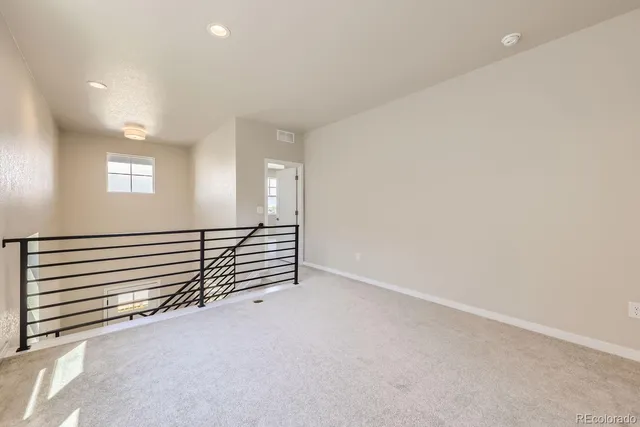 a view of a room with stairs and a window