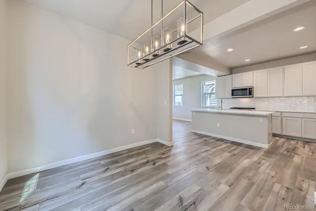 a view of a kitchen with a sink cabinets and wooden floor
