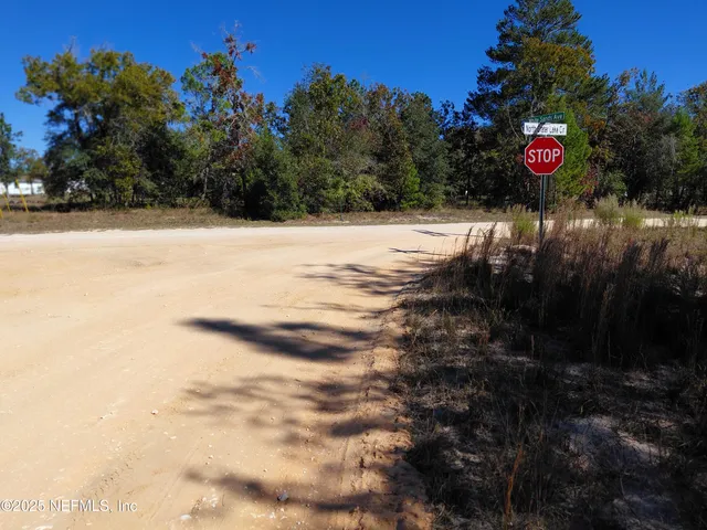 a view of white house with a yard