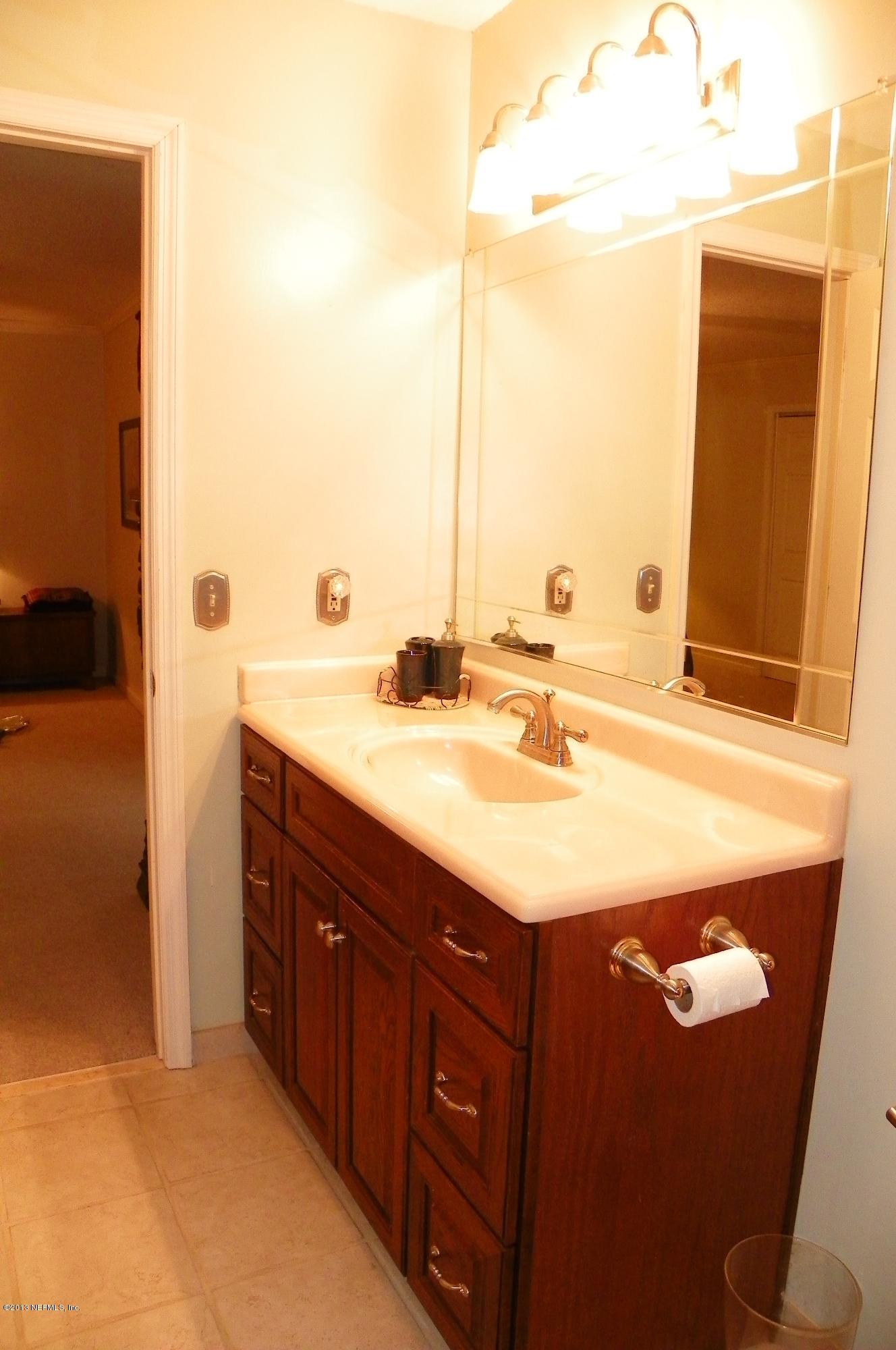 1138 Cactus Cut Road Middleburg, FL 32068 - Photo 12 of 43 a bathroom with a sink and a mirror