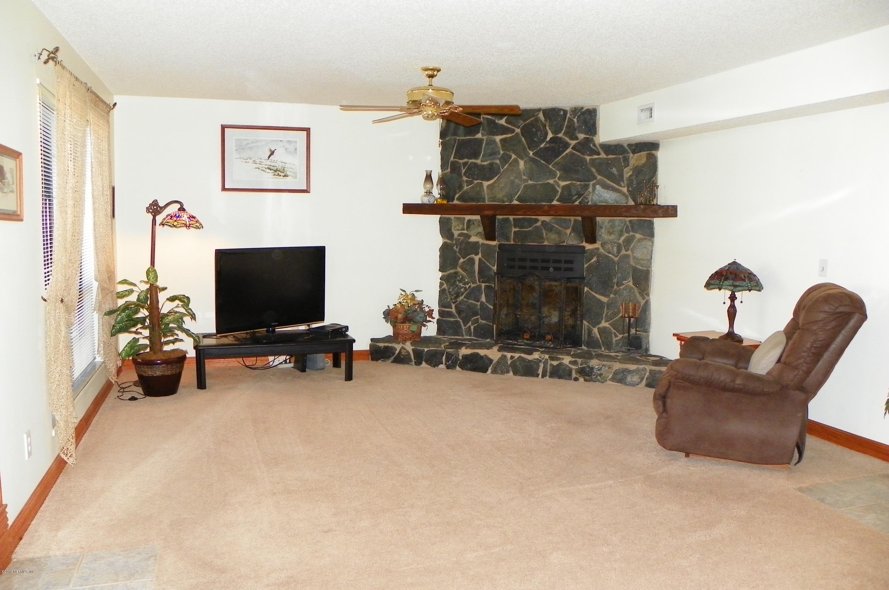 1138 Cactus Cut Road Middleburg, FL 32068 - Photo 8 of 43 a view of a livingroom with furniture and a flat screen tv