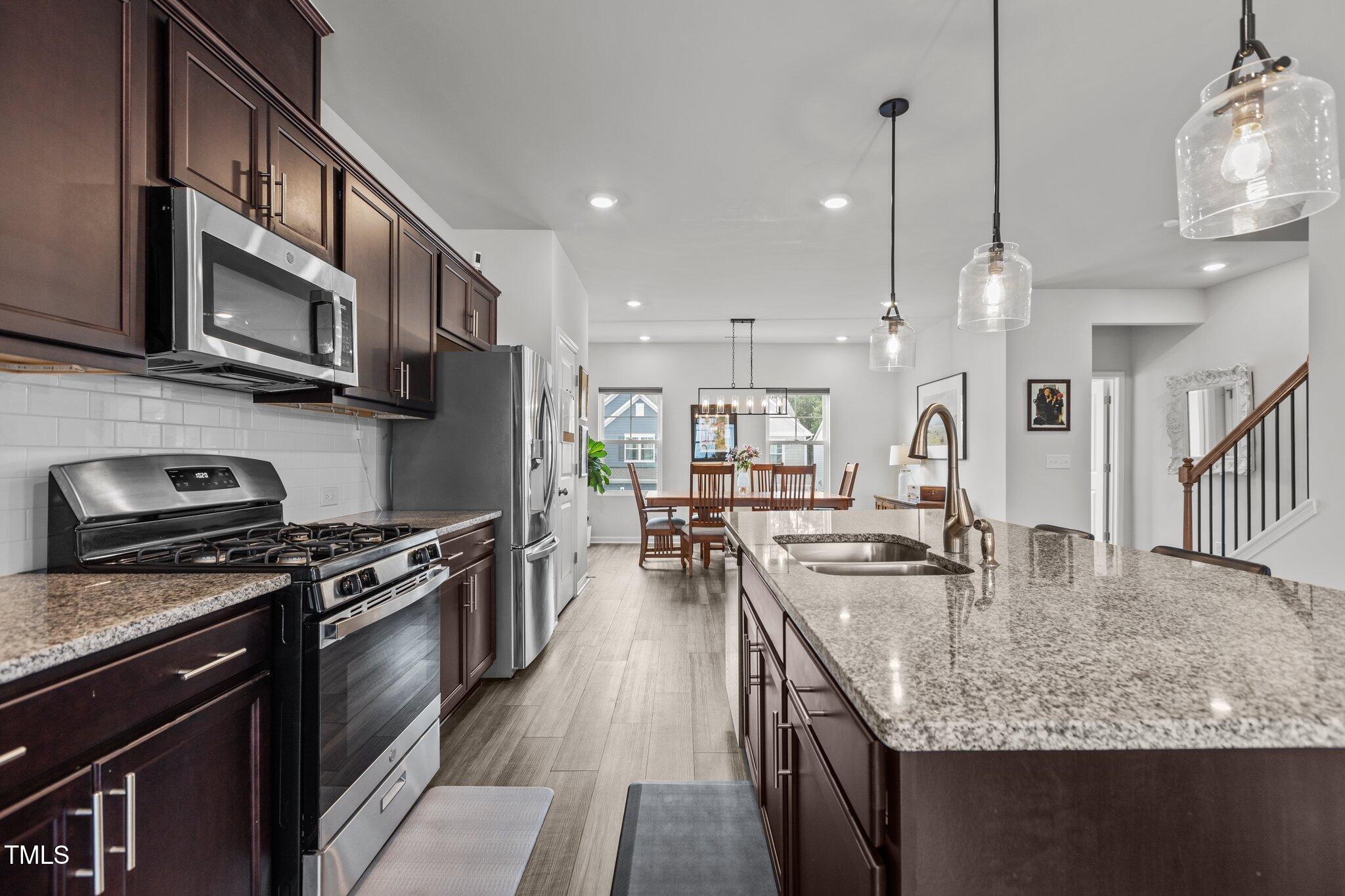 Kitchen - with granite countertops - features gas stove, pantry ...
