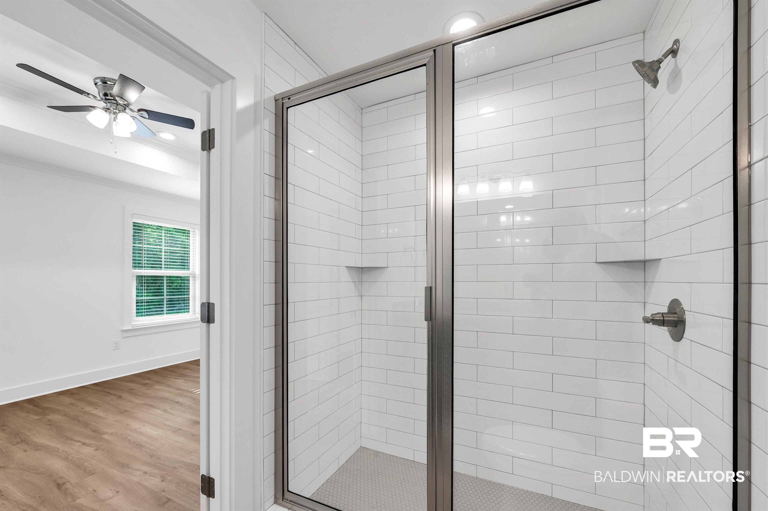 22045 8th Street Silverhill, AL 36576 - Photo 27 of 39 Full bath featuring a stall shower, wood finished floors, a ceiling fan, baseboards, and recessed lighting