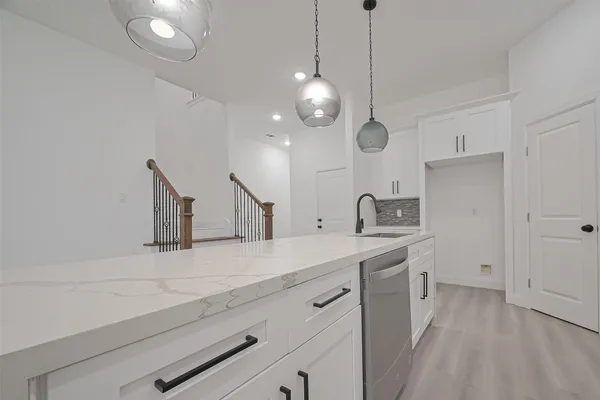 a kitchen with a sink and a refrigerator