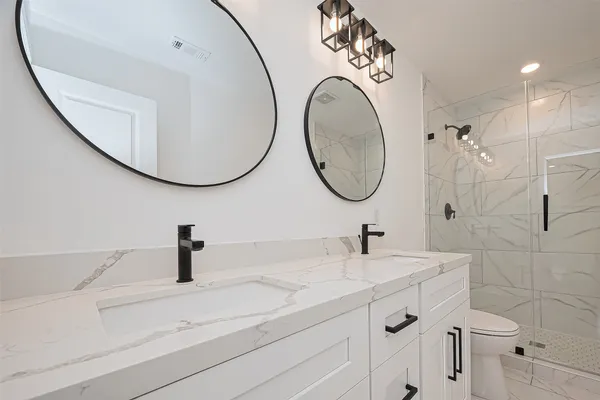 a bathroom with a sink mirror and toilet