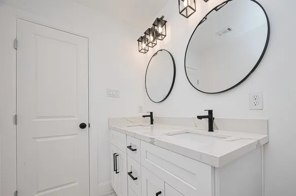 a bathroom with a sink and mirror