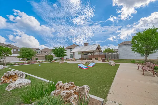 a view of a house with a yard and sitting area