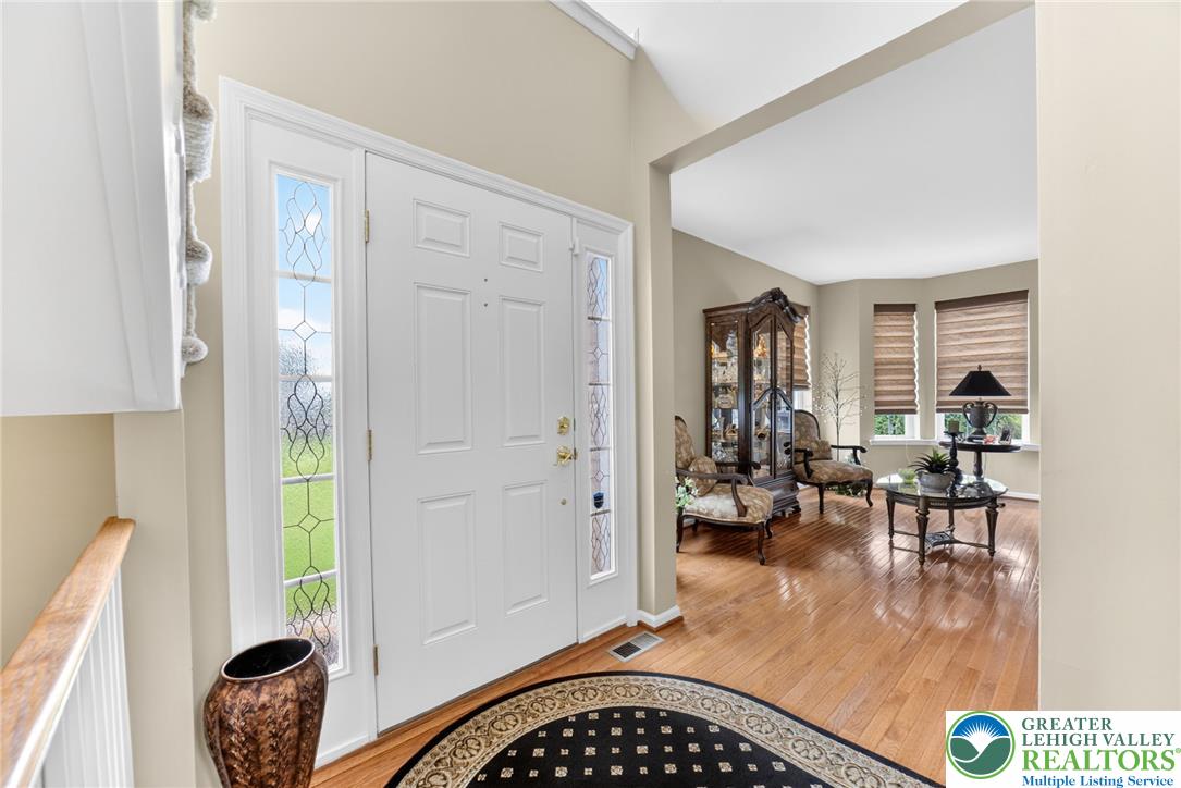 5440 Spring Ridge Drive West Macungie, PA 18062 - Photo 4 of 40 Enter through a grand entryway featuring hardwood floors and a naturally illuminated living space.