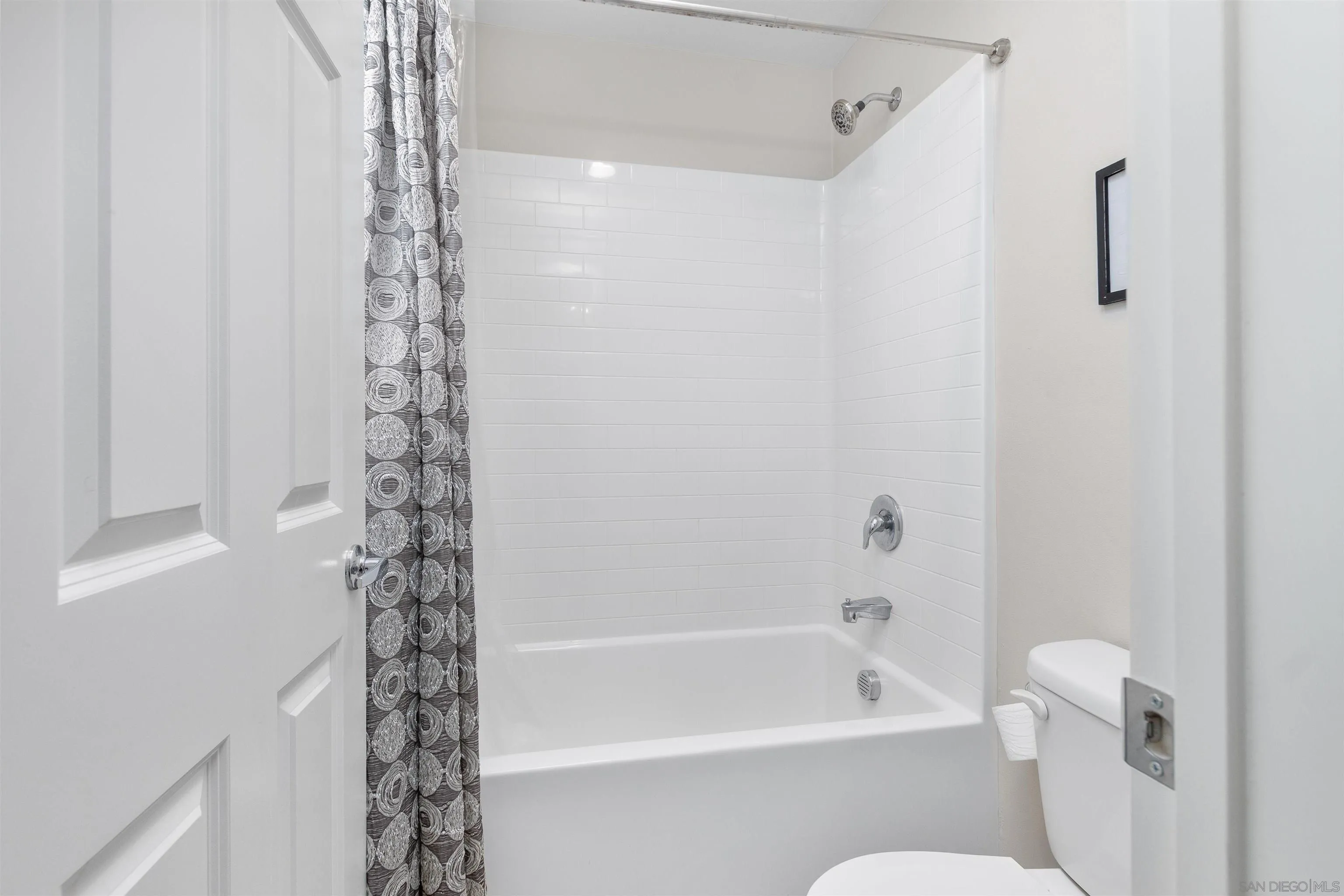 216 Oberlander Way Fallbrook, CA 92028 - Photo 18 of 31 a bathroom with a shower curtain and a toilet