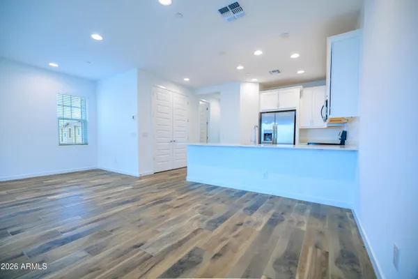 a view of a kitchen with a sink and a refrigerator