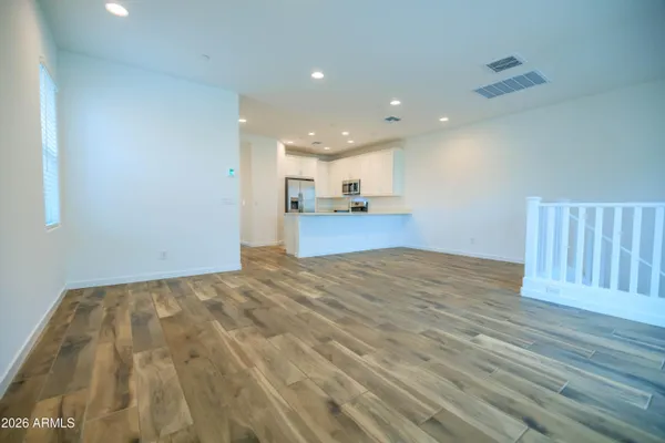 a view of a kitchen with wooden floor