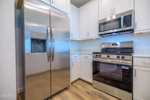 a kitchen with stainless steel appliances granite countertop a stove and a microwave