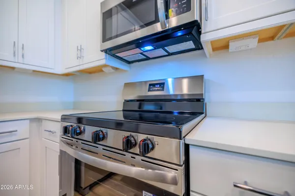 a stove top oven sitting inside of a kitchen