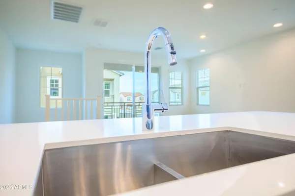 a view of open kitchen with granite countertop a large window